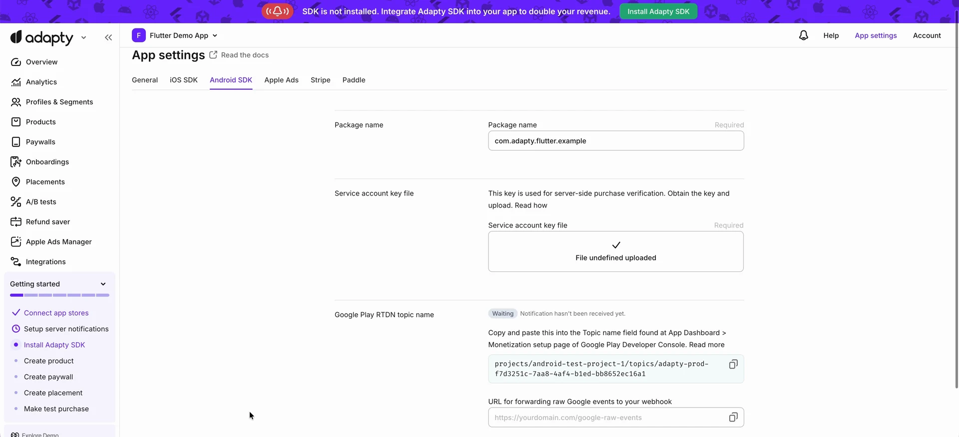 Google Play RTDN topic name section in Adapty App settings, with the generated topic name