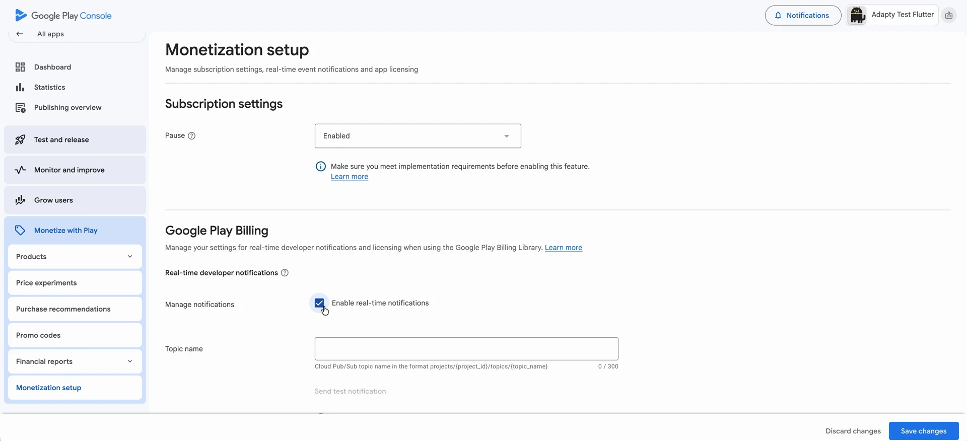 Monetization setup page in Google Play Console, showing the Enable real-time notifications checkbox and Topic name field